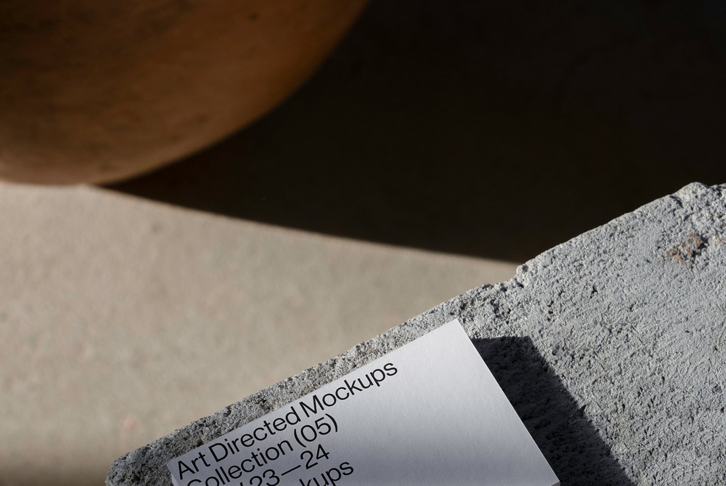 Minimalist mockup featuring textured concrete and paper design template. Ideal for designers seeking modern and artistic mockup assets for projects.