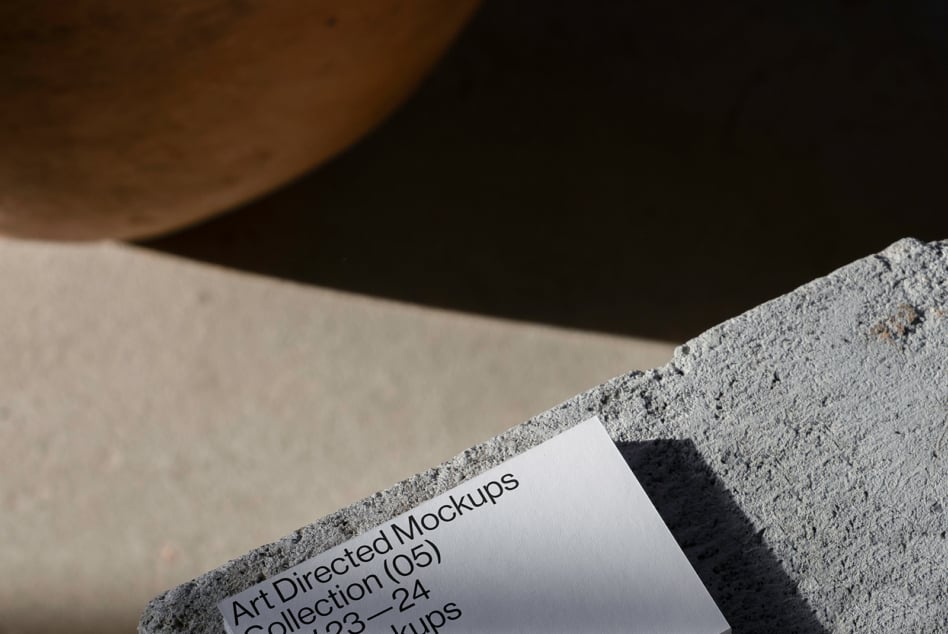 Minimalist mockup featuring textured concrete and paper design template. Ideal for designers seeking modern and artistic mockup assets for projects.