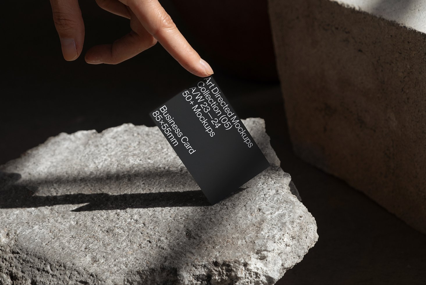 Business card mockup on textured stone surface perfect for designers showcasing branding templates and identity projects in realistic settings.