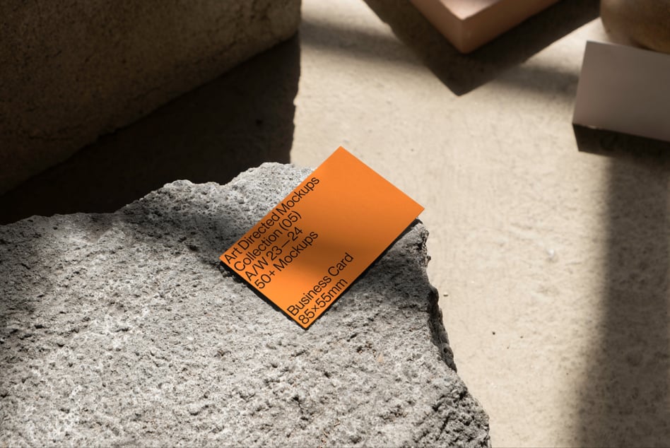 Orange business card mockup on concrete surface suitable for designers. High-quality mockups business card template PSD resource for creatives.