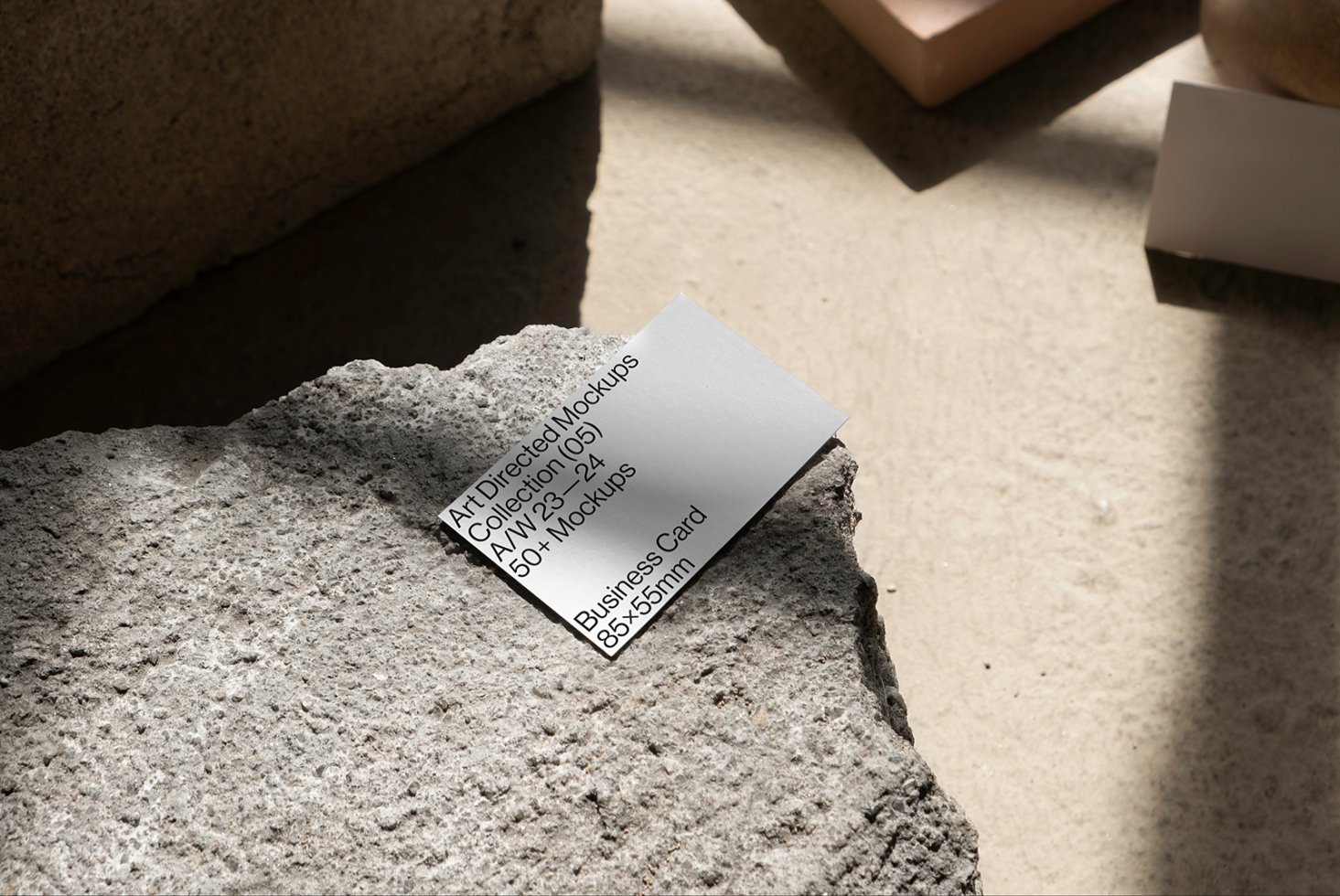Business card mockup on textured concrete surface, showcasing modern design for creative mockups, templates, design assets targeting graphic designers.