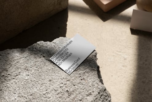 Business card mockup on textured concrete surface, showcasing modern design for creative mockups, templates, design assets targeting graphic designers.
