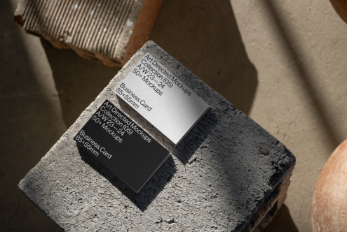 Business card mockups on concrete surface, showcasing minimalist design. Keywords: business card, mockup, design resources, branding, templates, graphics.
