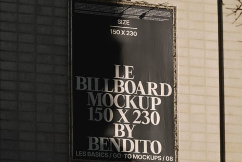 Billboard mockup on building wall featuring large white text on black background. Ideal for designers. Keywords: mockup template graphic design billboard.