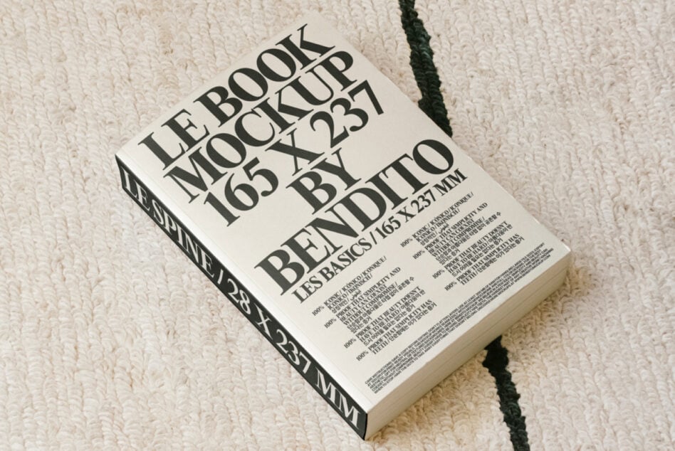 Off-white hardcover book with bold black typography for LE BOOK MOCKUP 165 X 237 BY BENDITO