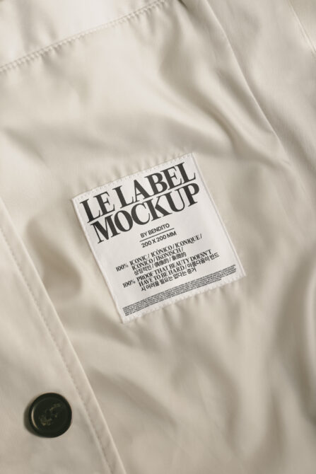White fabric with sewn-on care label showing multilingual text on cream background