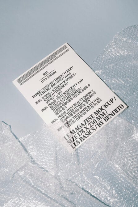 Magazine mockup angled shot on light surface with packing material