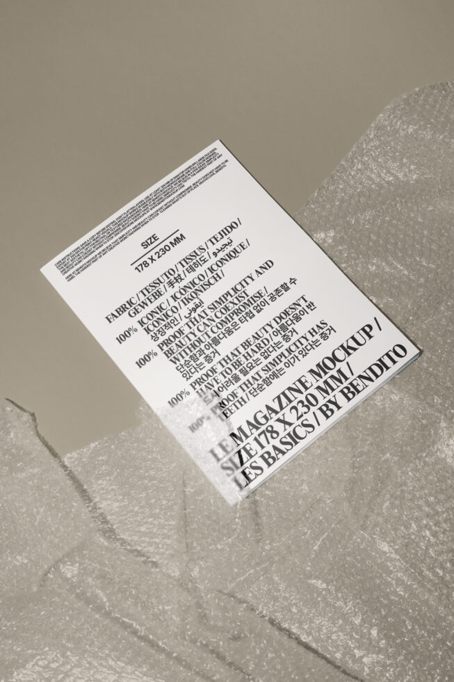 Magazine mockup on grey surface with bubble wrap. Perfect for showcasing print designs and layouts. Keywords: mockup, magazine, design, layout, bubble wrap.