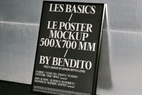 Modern 500x700mm poster mockup displayed in a sleek black frame leaning against a textured wall ideal for designers featuring bold typography