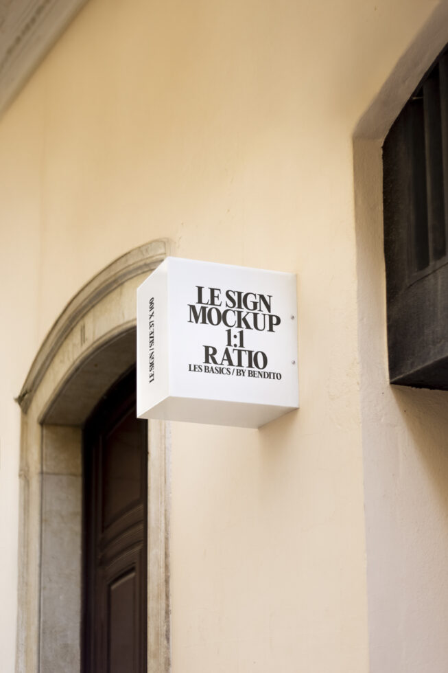 Cube sign mockup on beige wall for designers showcasing branding graphics and templates with realistic outdoor ambiance; ideal for signage projects.