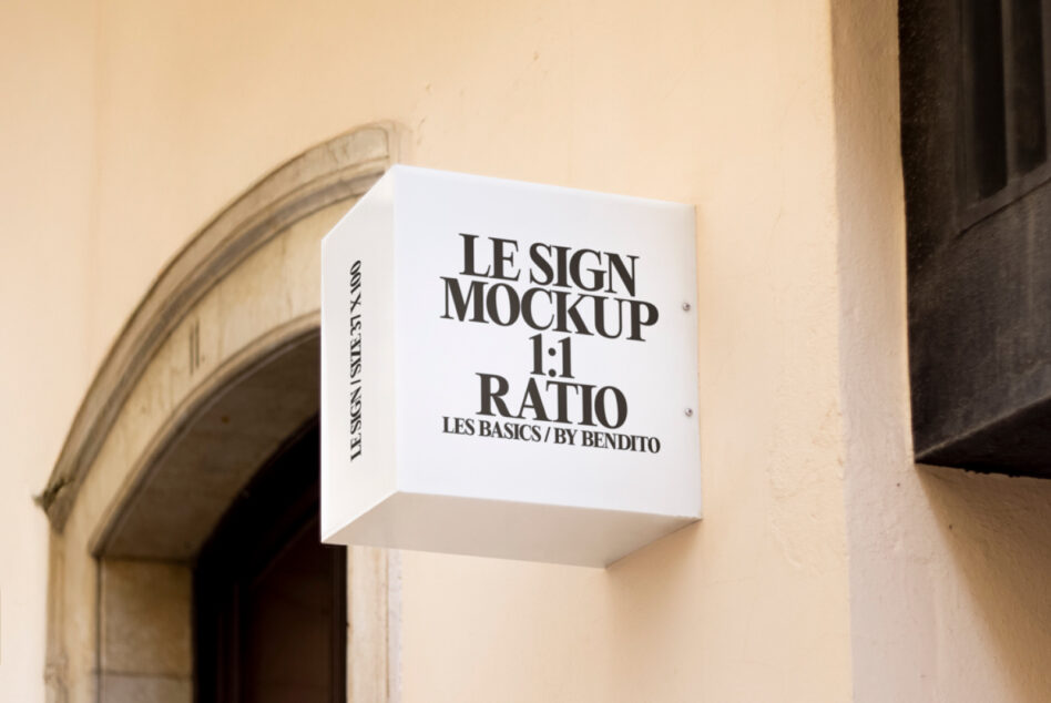 White box storefront sign with black serif lettering mounted on wall
