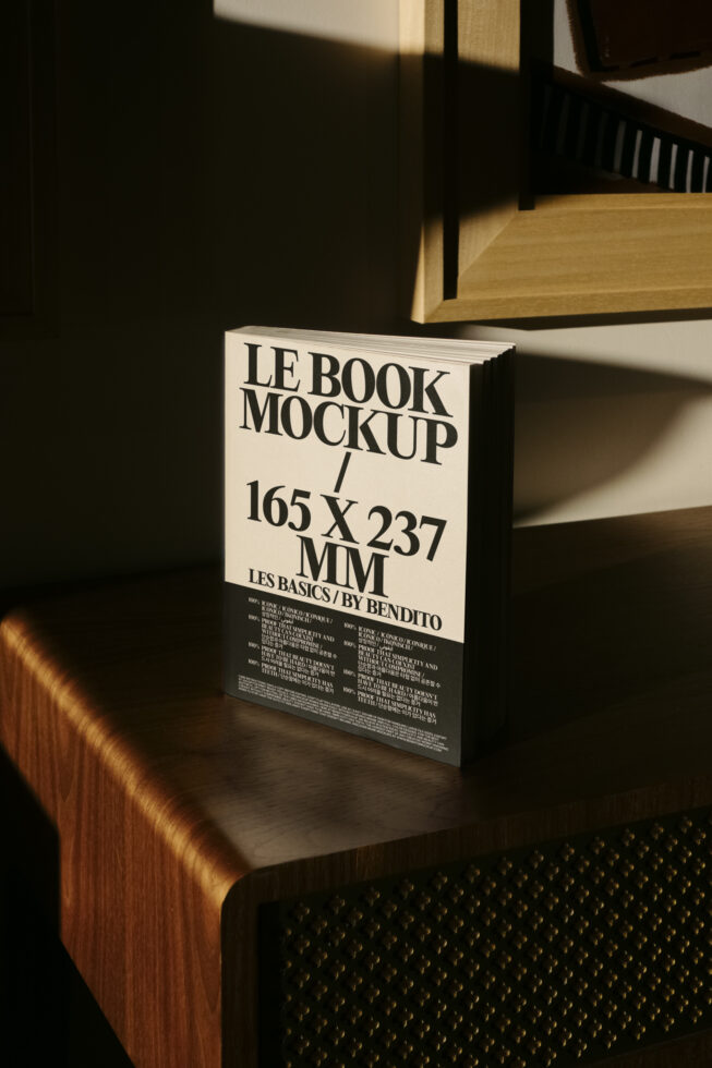 Open book mockup on desk with cream pages showing Les Basics branding