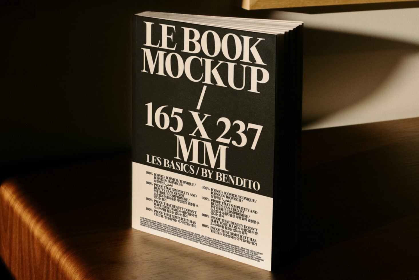 Black hardcover book mockup standing upright showing cream spine text detail