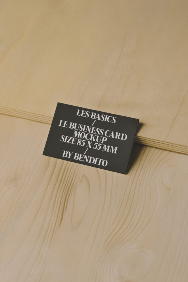 Business card mockup on wooden surface showcasing design template for branding. Perfect for designers seeking professional presentation.