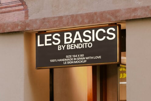 Shop sign mockup on a beige wall with text Les Basics by Bendito showcasing realistic signage design perfect for branding and retail display templates.