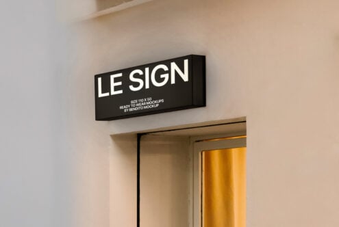 Rectangular wall sign mockup for designers. Displayed on a beige wall above a door. Ideal for branding presentations, commercial graphics, storefront signage.