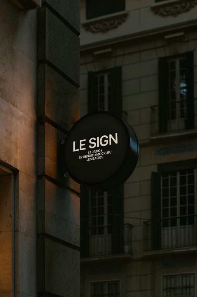 Round sign mockup on urban building exterior with dark background for branding presentations and graphic design projects. Ideal for designers.
