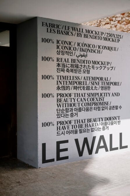 Light gray fabric wall mockup with large typography in minimalist interior