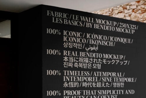 Fabric wall mockup by Bendito Mockup showing multilingual bold typography on a dark surface. Ideal for designers seeking unique and iconic mockup templates.