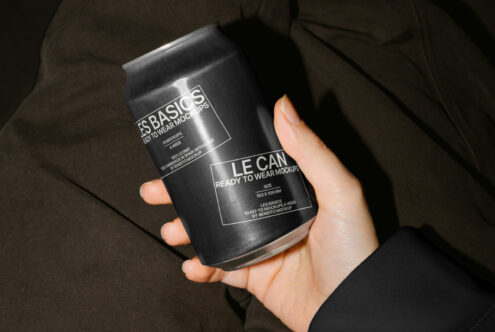 Hand holding a sleek black can with customizable design template perfect for beverage packaging mockups ideal for designers seeking modern graphics