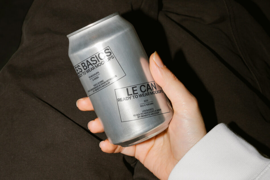 Brushed silver aluminum can mockup in hands wearing casual dark jacket