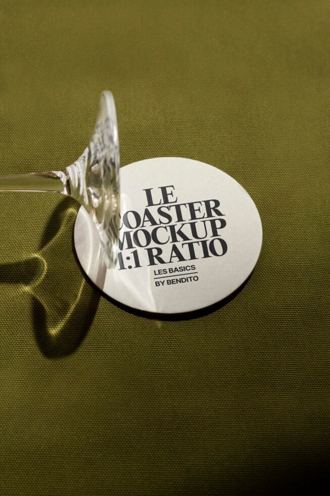 Coaster mockup on olive fabric with a clear glass shadow, showcasing minimalist design. Perfect for designers seeking realistic presentation templates.