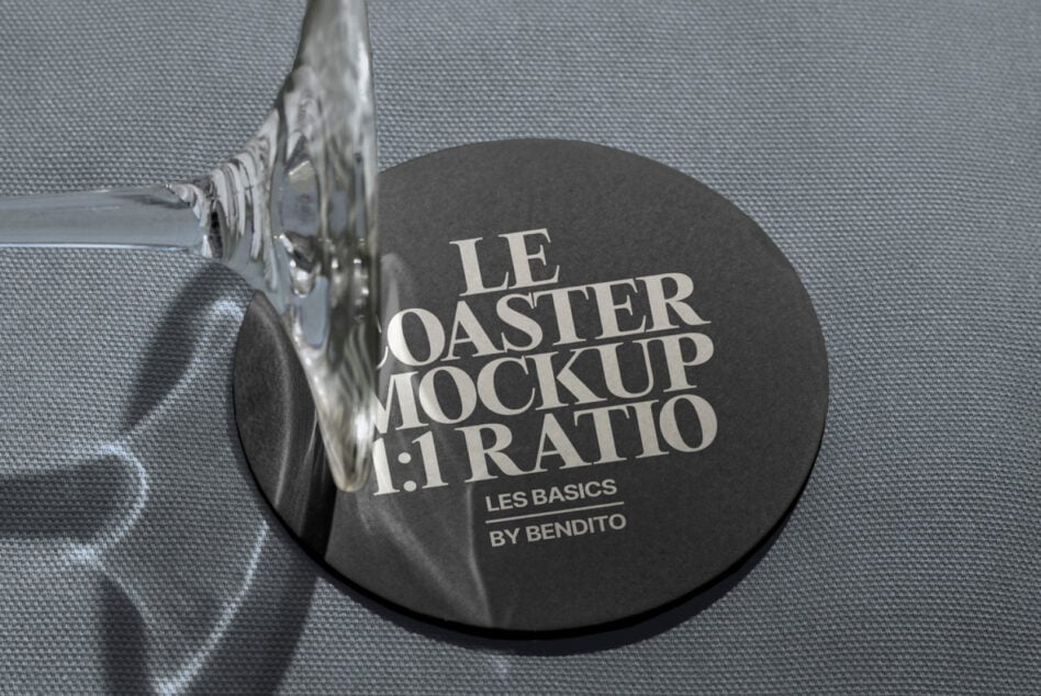 Dark round coaster mockup with decorative metal handle on gray linen surface