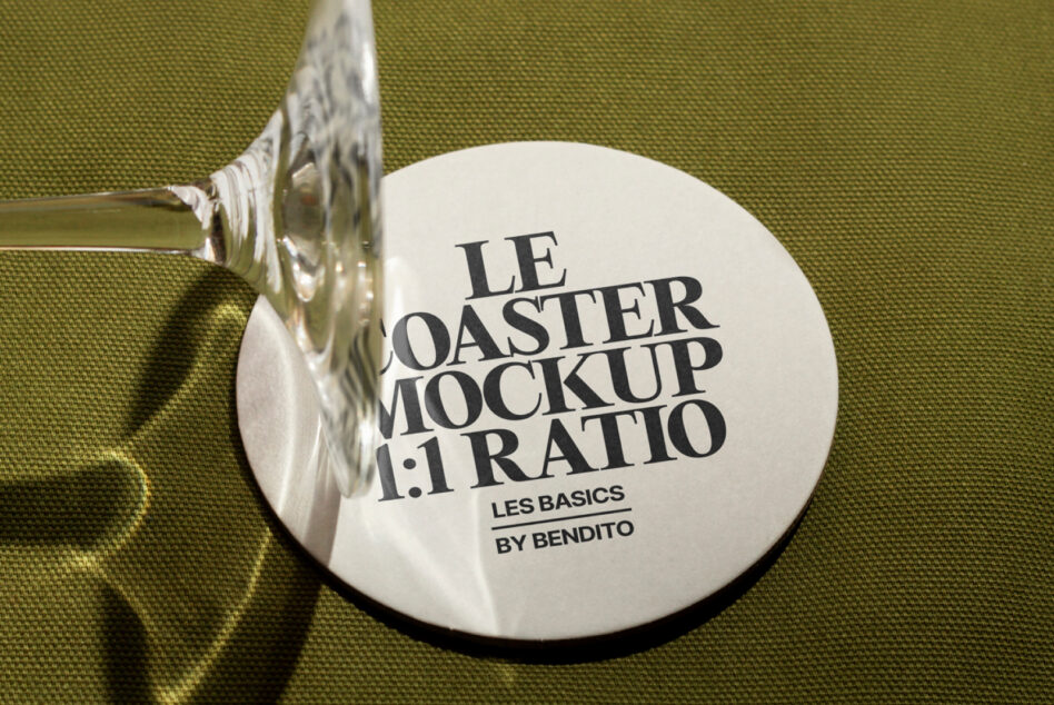 White round coaster mockup with silver handle on moss green fabric backdrop