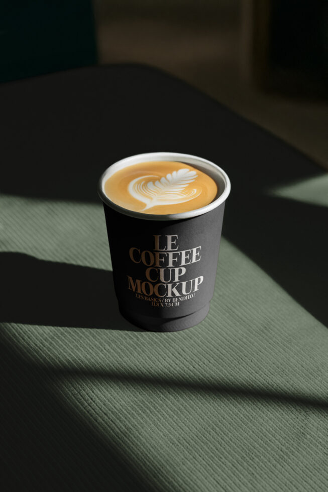 Coffee cup mockup with elegant latte art design placed on a textured surface. Ideal for designers seeking high-quality templates for branding projects.