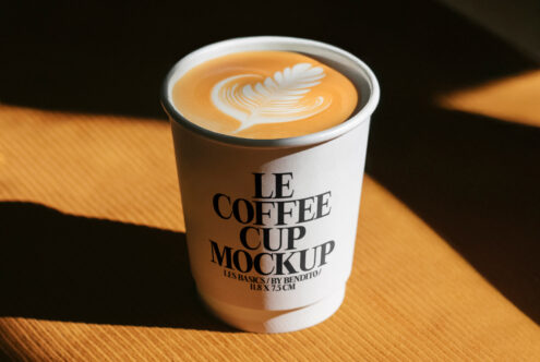 Coffee cup mockup featuring latte art for designers. Ideal for showcasing branding designs in a realistic setting. Mockup template asset.