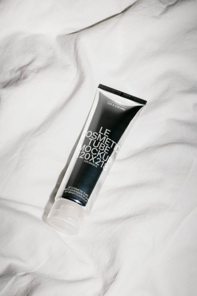 Cosmetic tube mockup on fabric surface ideal for designers. High-resolution PSD template for beauty product packaging. Perfect for branding and presentations.