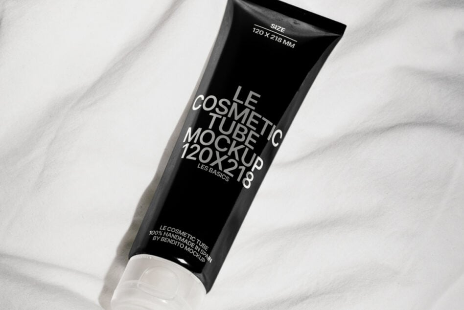 Black squeeze tube on marble surface showing cosmetic branding at angle view