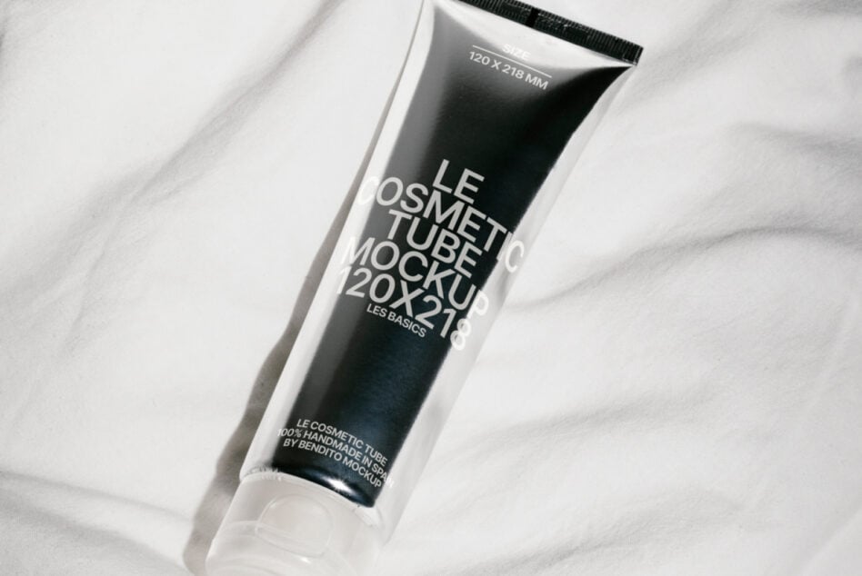 Clear squeeze tube mockup on white marble featuring black label design visible through
