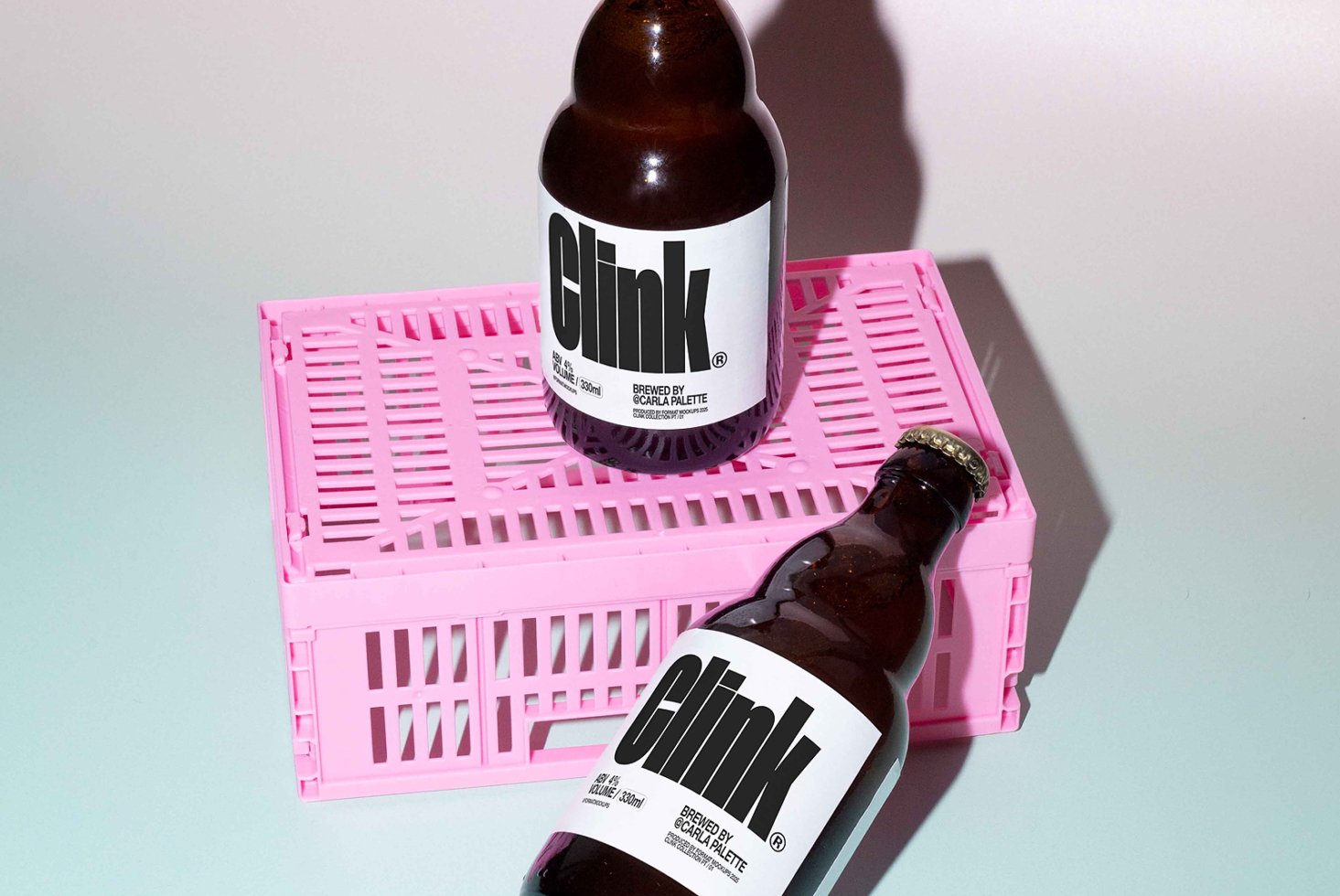 Glass bottles with bold text labels on pink crate minimalist design perfect for mockup projects product presentation and branding for designers