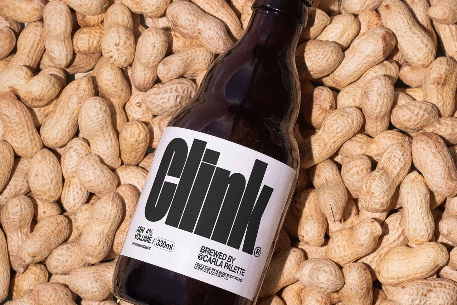 Beer bottle mockup with bold black label on peanuts background ideal for branding or packaging designers looking for unique product graphics.