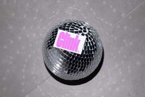 Disco ball tile texture topped with a vibrant pink sticker design Clink logo art reflective creative graphic design asset trendy mockup for designers