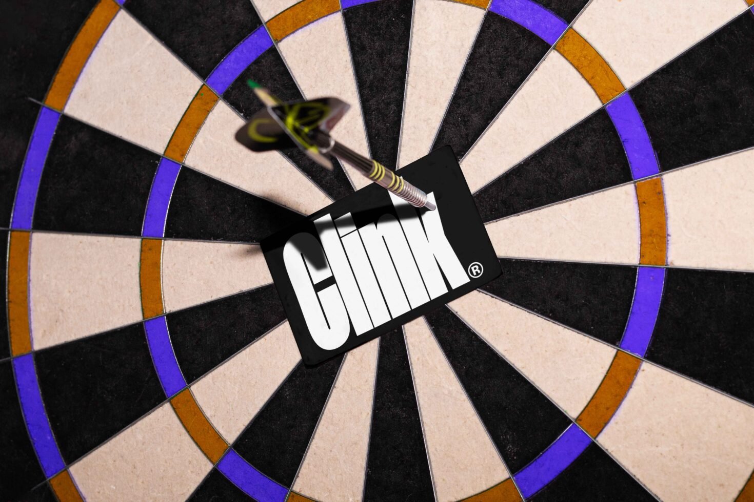 Dartboard bullseye with dart striking card reading Clink suitable for graphic design. Keywords: mockup, graphics, design asset, target, creative.