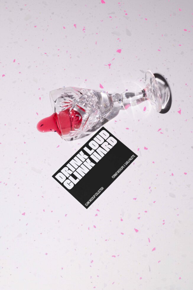 Crystal glass tipped over with red liquid, next to a bold font card reading Drink Loud Clink Hard. Ideal for graphic design templates and mockups.