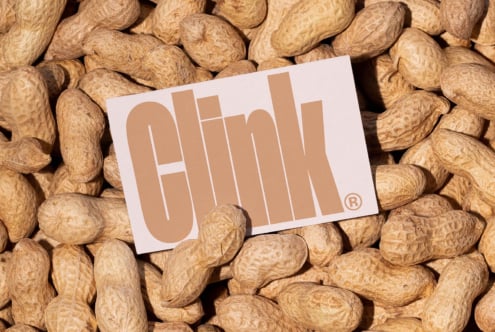 Business card mockup on pile of peanuts showcasing bold typography design. Ideal for branding, graphic designers, creative template resource.