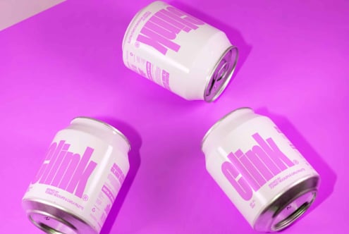 Three white beverage cans with bold purple text 'Clink' on vibrant purple background. Ideal for branding mockups, packaging design, product showcases.