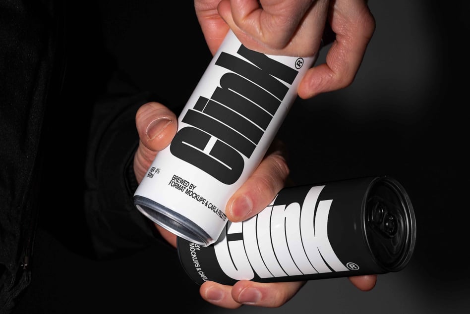 Hand holding two beer cans with black curved label on white background