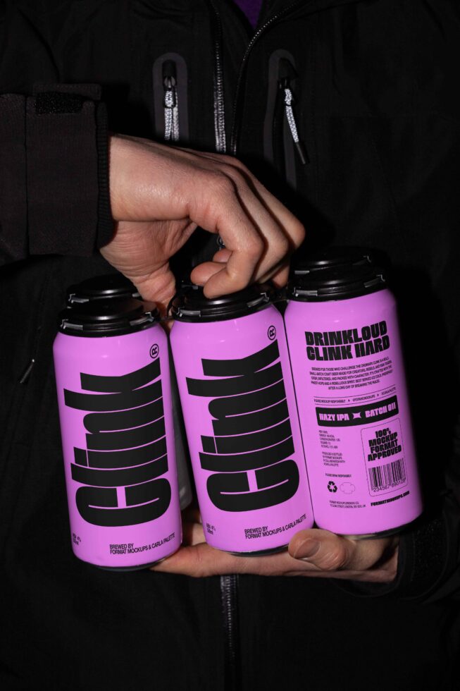 Person holding three purple cans with bold black text label, ideal for mockup design. Keywords: beverage, can, mockup, packaging design, graphic template.