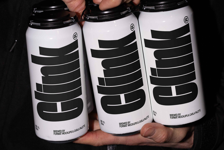 Three white beer cans with black horizontal stripe design held in hands
