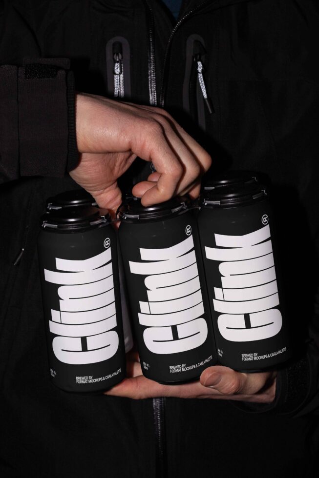 Person holding three black cans with bold typography saying clink suitable for mockup design showing branding packaging for designers and creatives