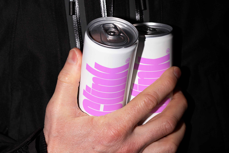 Two slim cans with bright magenta stripes on white background held up