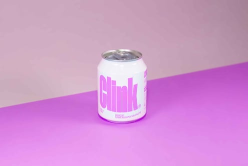 Mockup of a soda can with bold pink text on a light background. Ideal for designers looking for beverage branding or packaging design assets.