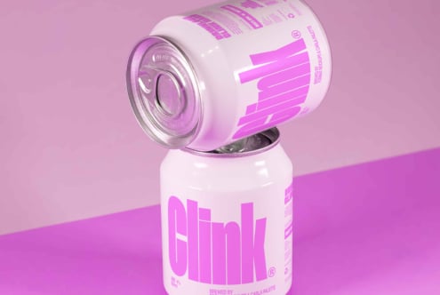Stack of two pink soda cans with bold typography design on purple background ideal for product mockups digital asset for designers and branding projects