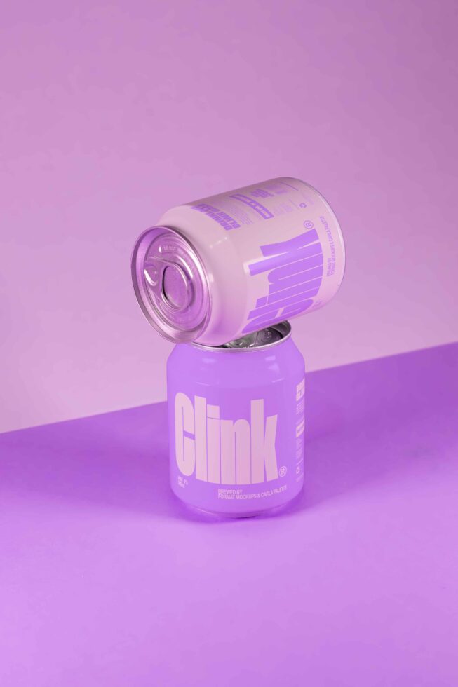 Two purple soda cans, one on top of the other, on a matching purple background. Perfect for product branding mockup or packaging design templates.