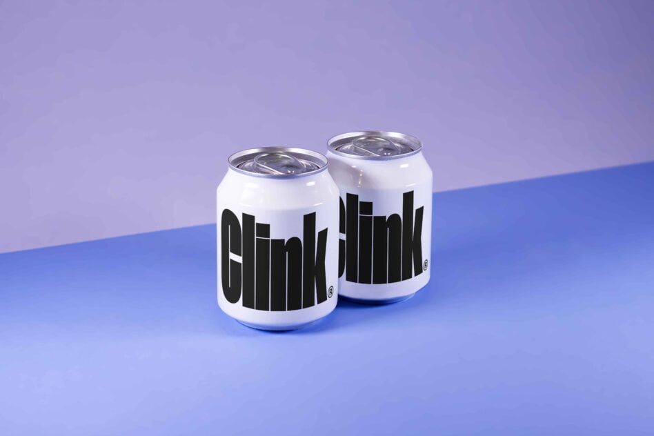 Two soda cans with bold black text design, placed on a gradient background. Perfect for use in branding mockups and packaging design assets.