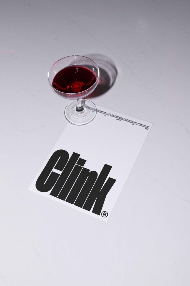 Mockup featuring a wine glass casting a shadow over a white card with bold black Clink font design ideal for graphic designers and branding projects.